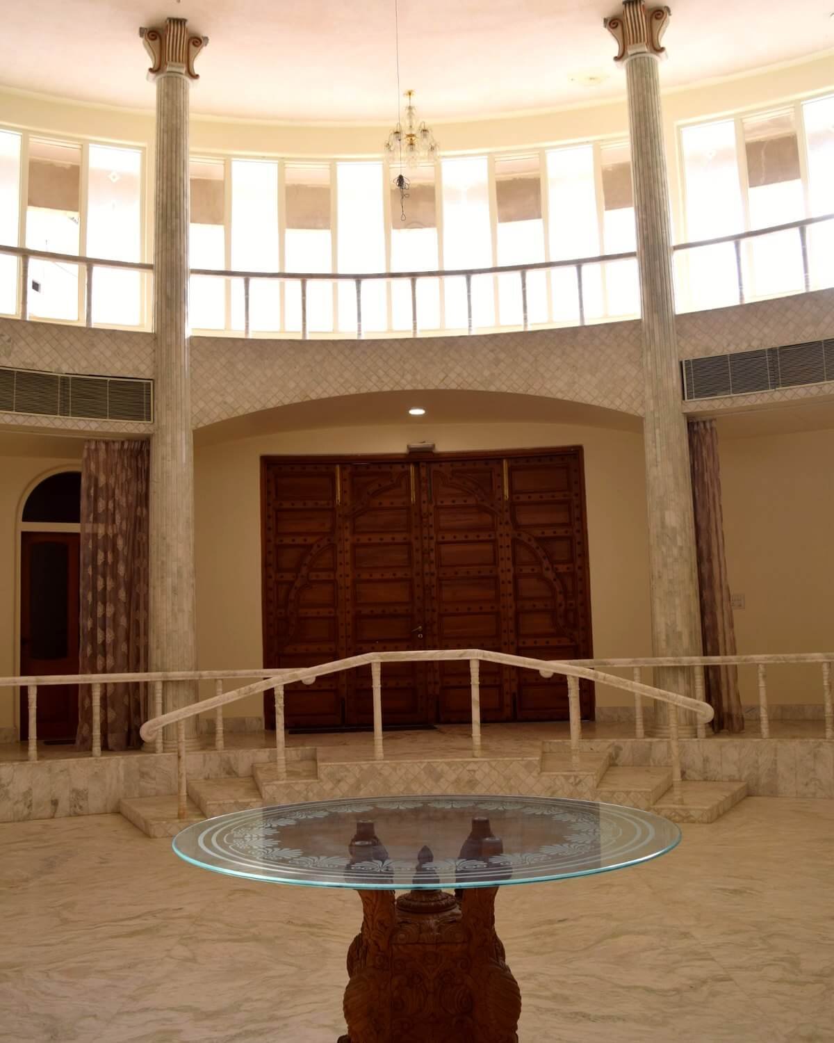 The Grand Hall with marble columns and ornate wooden double doors